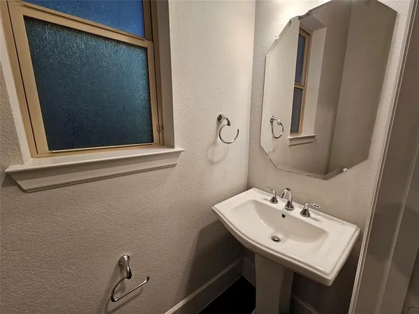 a bathroom with a sink and mirror