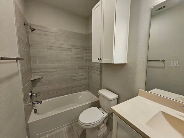 a bathroom with a toilet a sink and bathtub