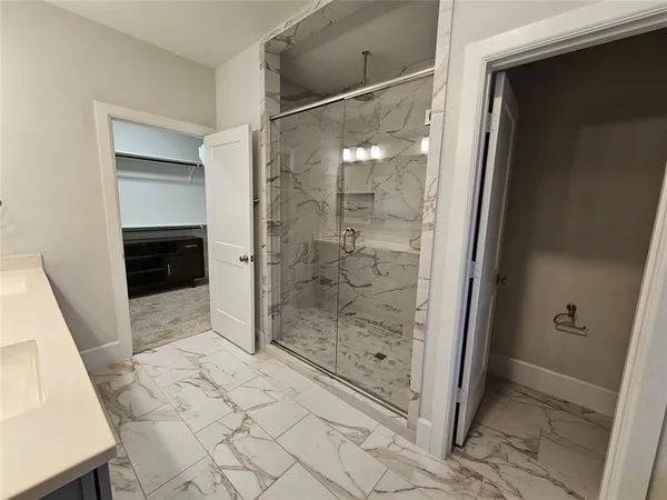 a bathroom with a glass door shower