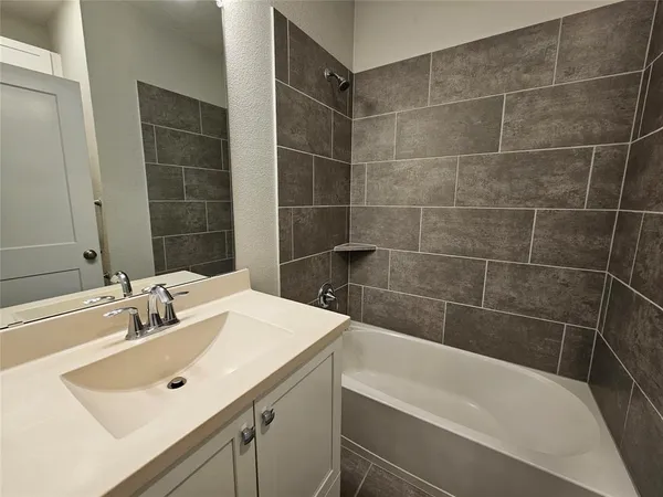 a bathroom with a sink mirror toilet and bathtub
