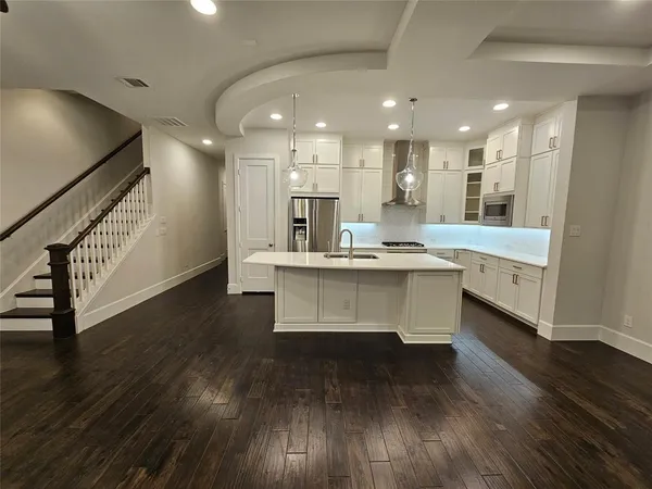 a view of kitchen with cabinets and wooden floor