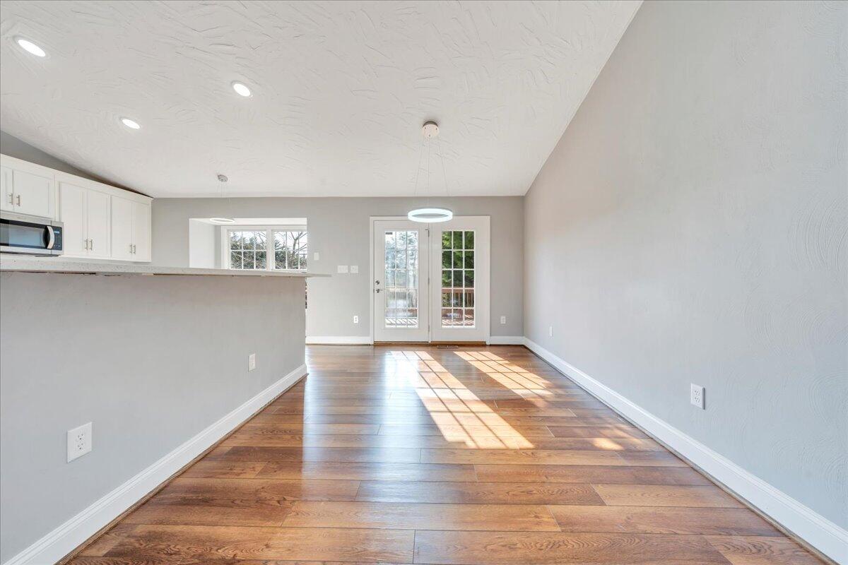 1510 Navigation Point Goodview, VA 24095 - Photo 11 of 48 a view of an empty room with wooden floor and a window