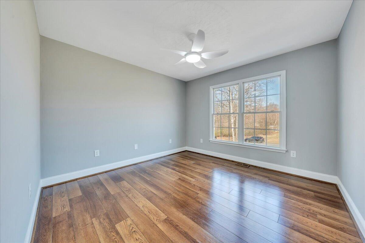 1510 Navigation Point Goodview, VA 24095 - Photo 21 of 48 a view of an empty room with wooden floor and a window