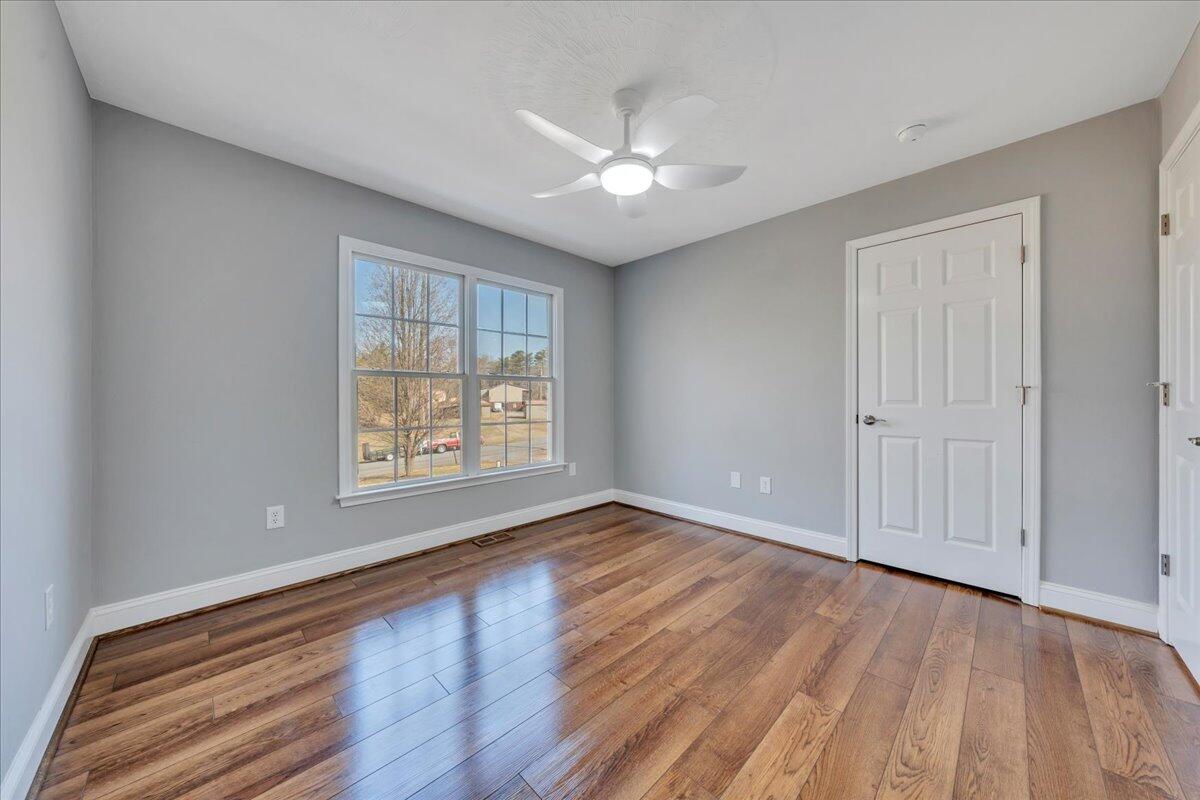 1510 Navigation Point Goodview, VA 24095 - Photo 22 of 48 a view of an empty room with wooden floor and a window