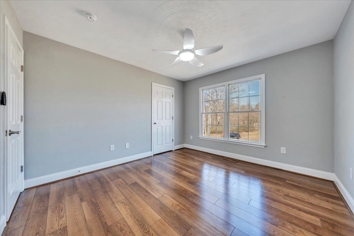 1510 Navigation Point Goodview, VA 24095 - Photo 24 of 48 a view of an empty room with wooden floor and a window
