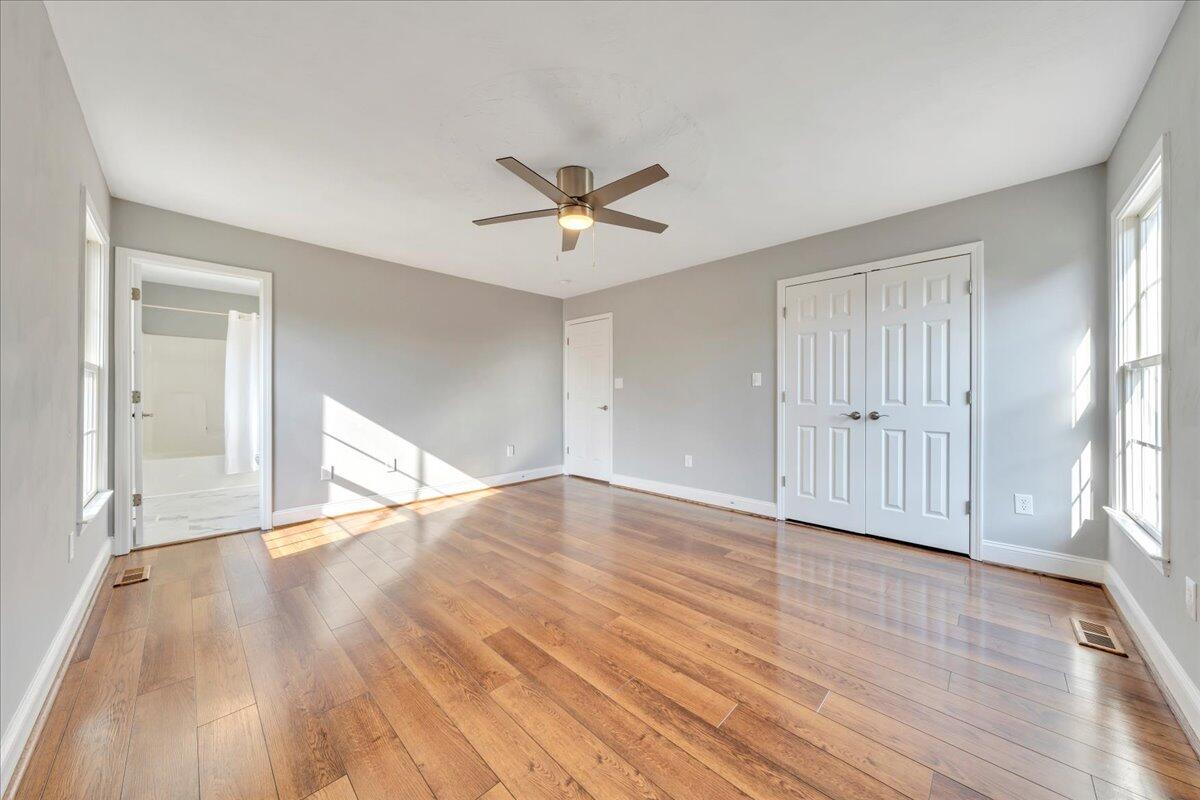 1510 Navigation Point Goodview, VA 24095 - Photo 26 of 48 a view of an empty room with wooden floor and a window