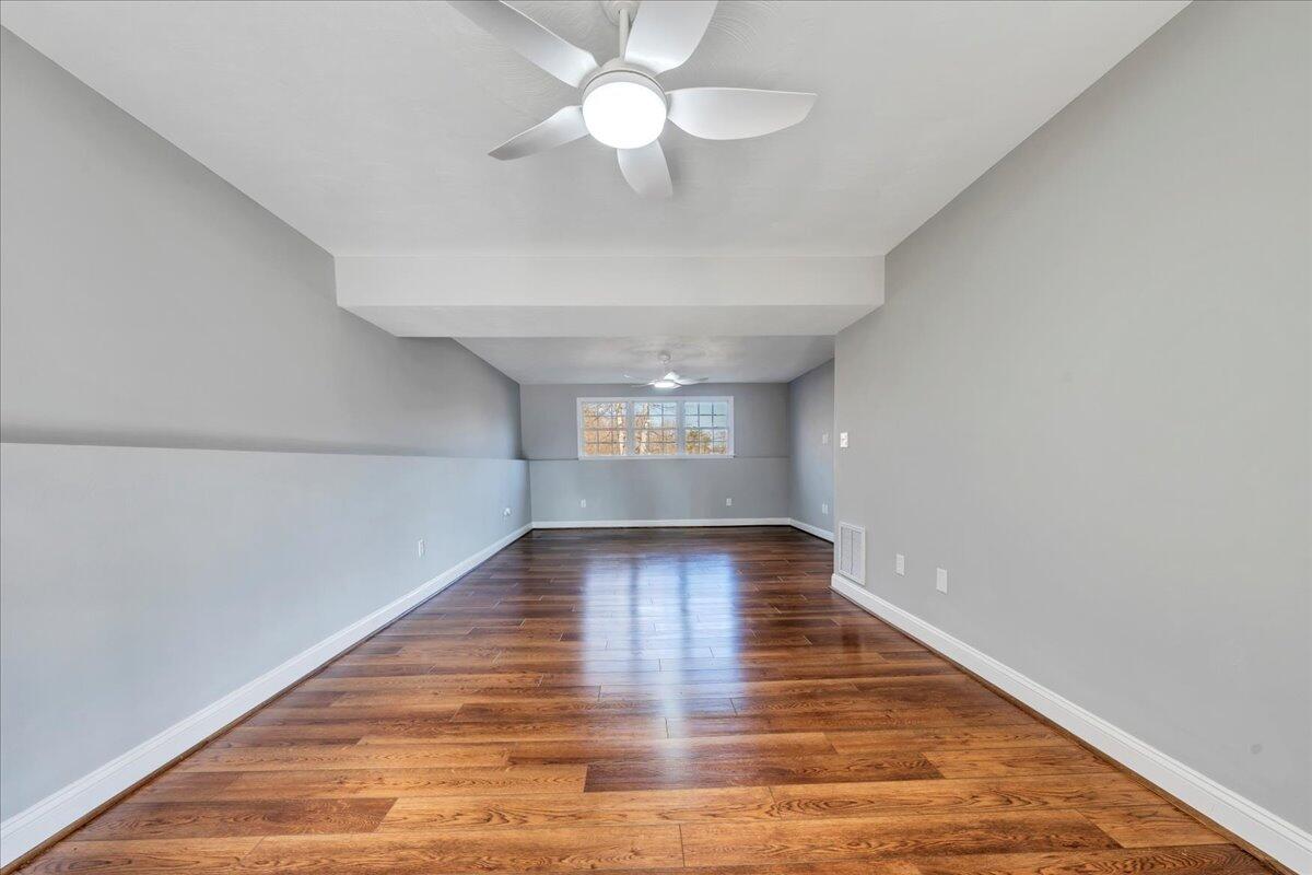 1510 Navigation Point Goodview, VA 24095 - Photo 29 of 48 a view of an empty room with window and wooden floor
