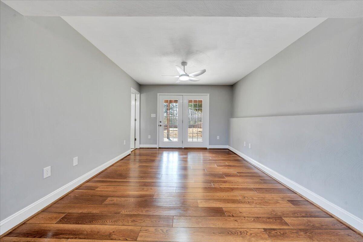 1510 Navigation Point Goodview, VA 24095 - Photo 32 of 48 a view of an empty room with wooden floor and fan