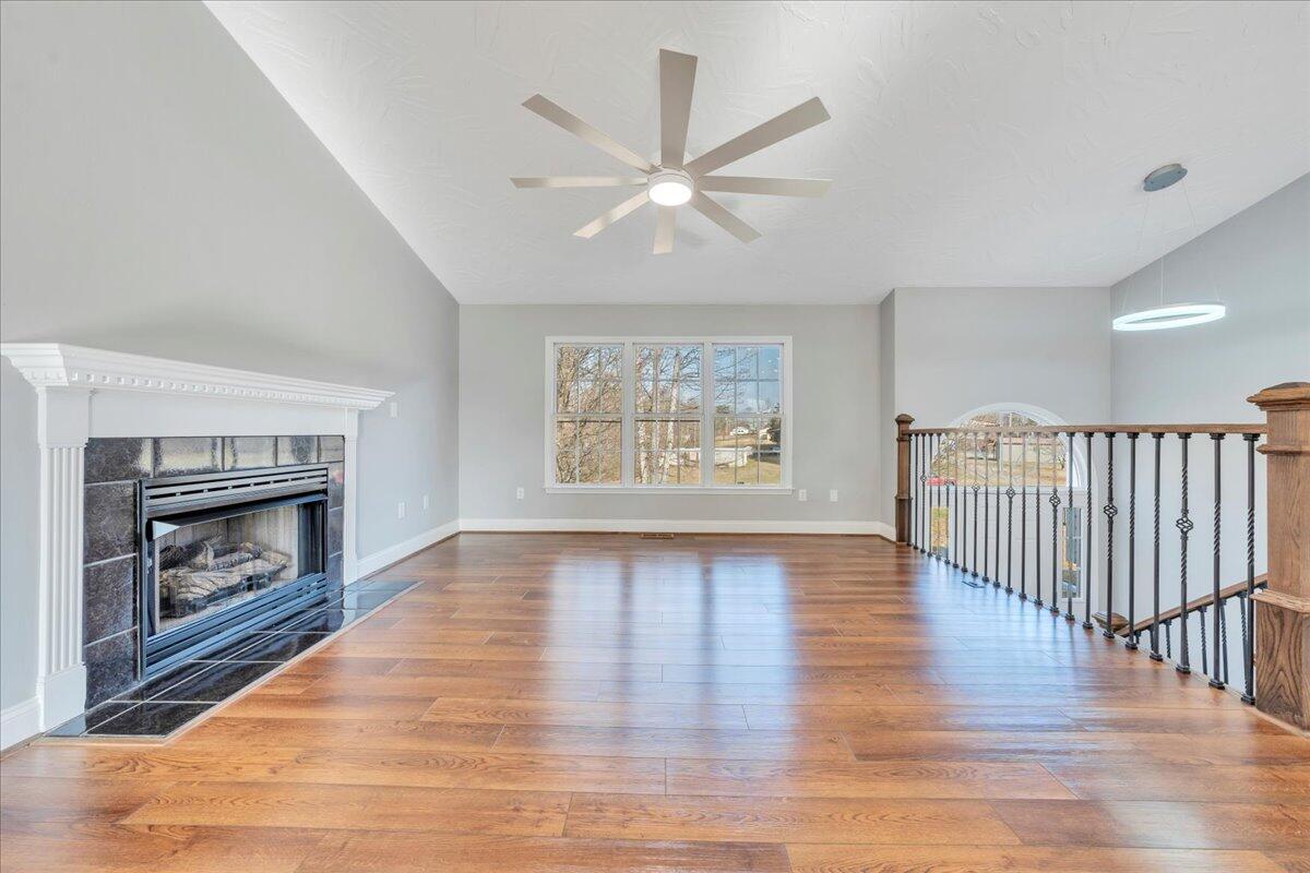 1510 Navigation Point Goodview, VA 24095 - Photo 6 of 48 a view of an empty room with wooden floor and a fireplace