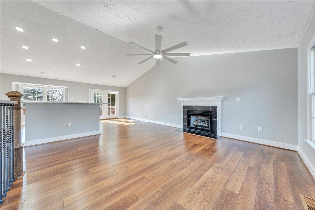 1510 Navigation Point Goodview, VA 24095 - Photo 9 of 48 an empty room with wooden floor fireplace and windows