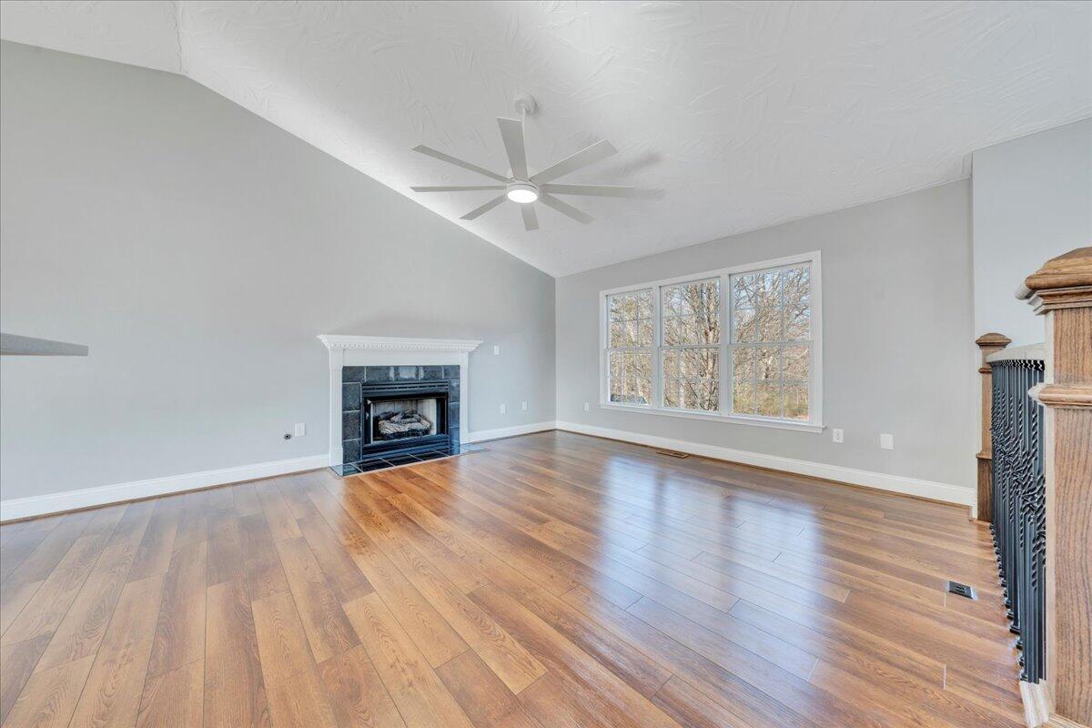 1510 Navigation Point Goodview, VA 24095 - Photo 10 of 48 an empty room with wooden floor fireplace and windows