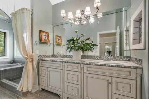 a bathroom with a sink vanity granite and a mirror
