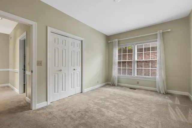 a living room with furniture and floor to ceiling windows