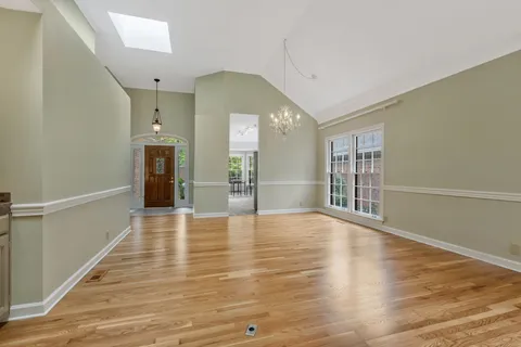 a view of empty room with wooden floor and fireplace