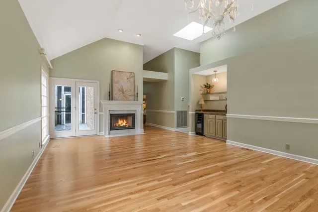 a living room with fireplace furniture and a chandelier