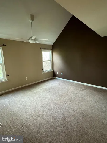 an empty room with a empty space and windows