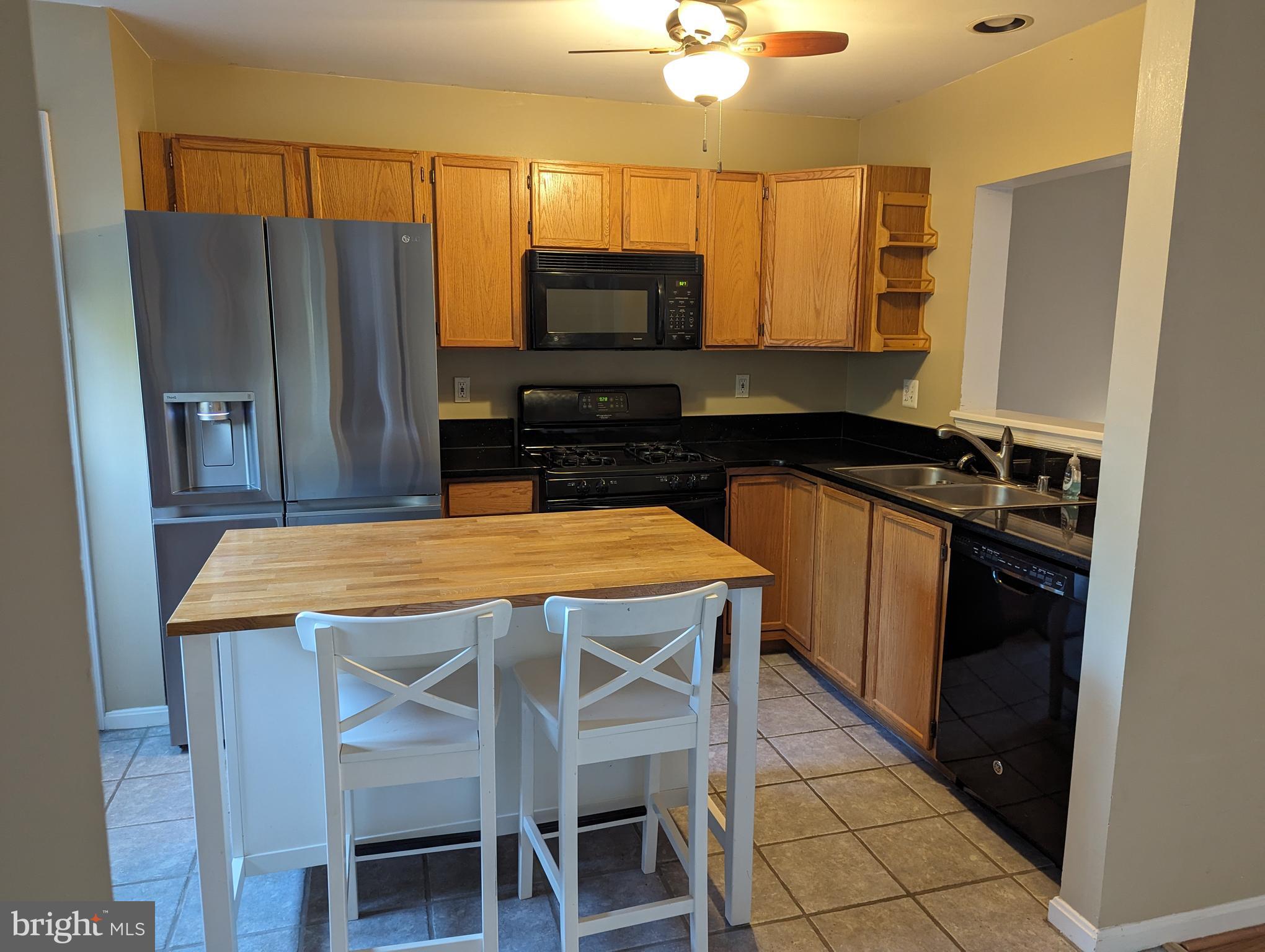 2109 Taylor Court Abingdon, MD 21009 - Photo 2 of 27 a kitchen with stainless steel appliances a microwave a stove and refrigerator