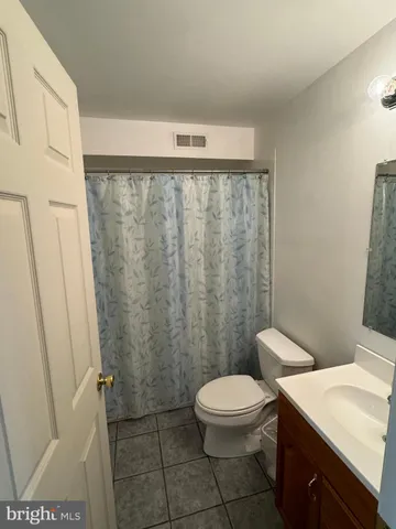 a white toilet sitting next to a bathroom sink