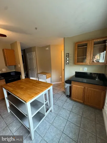 a spacious bedroom with a bed and a dresser in it