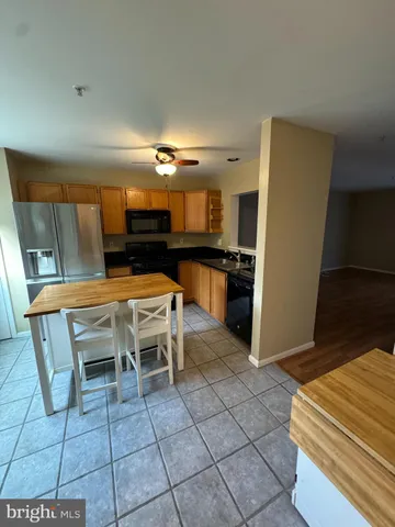 a dining room with furniture and kitchen view