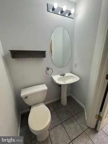 a bathroom with a toilet a sink and a mirror