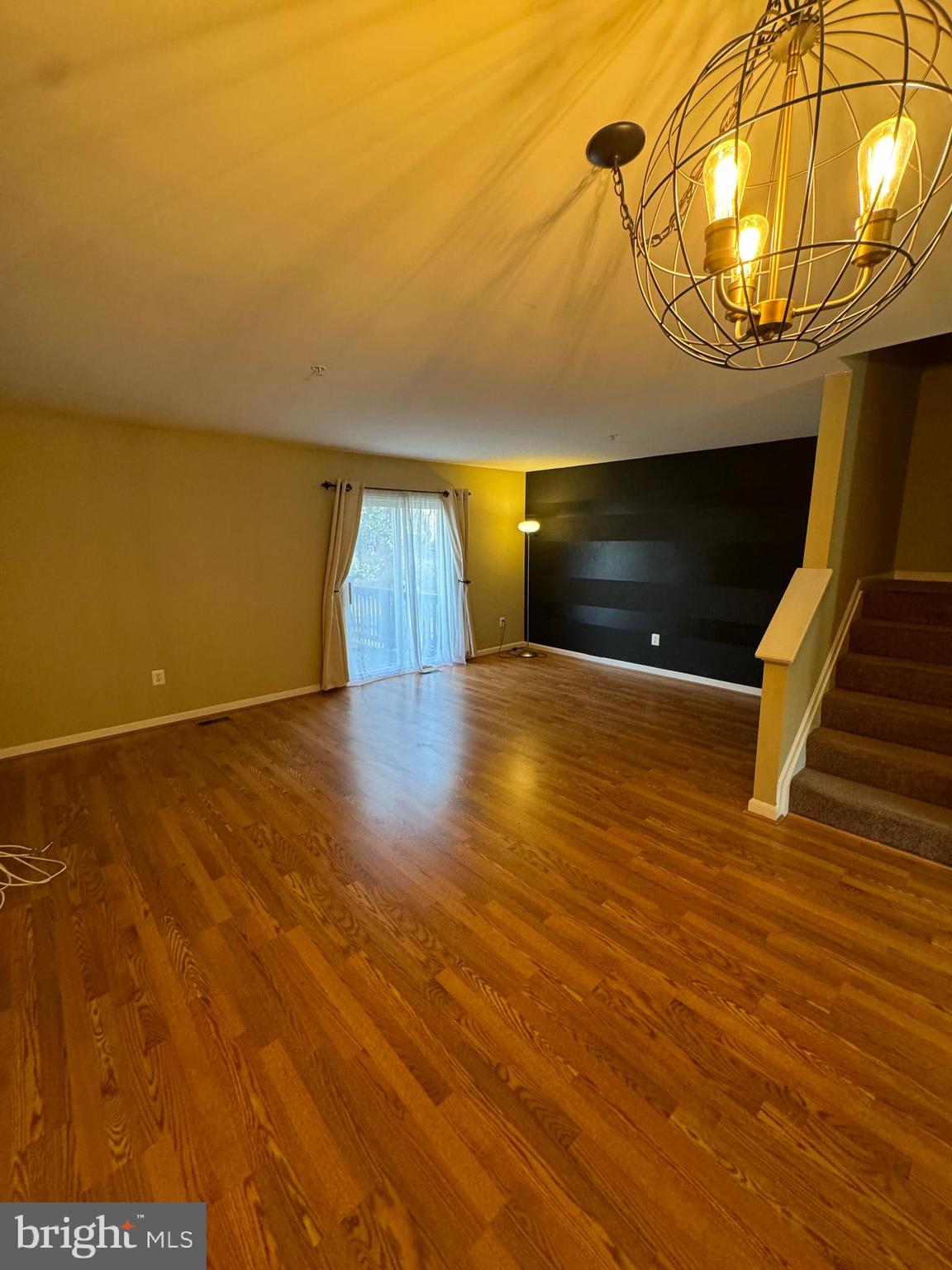 2109 Taylor Court Abingdon, MD 21009 - Photo 7 of 27 a view of an empty room with wooden floor and a chandelier