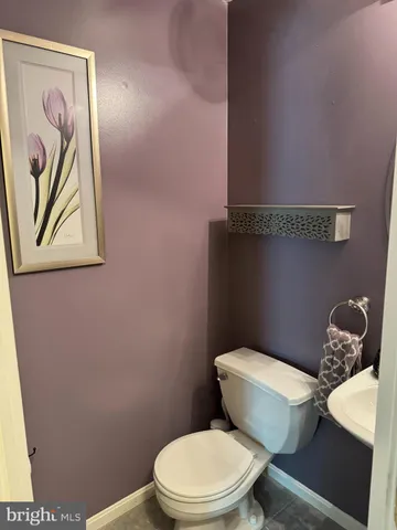 a white toilet sitting next to a small bathroom