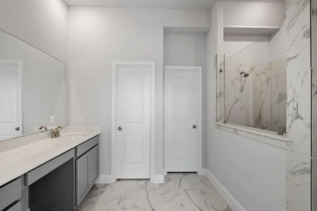 a spacious bathroom with a shower and a sink