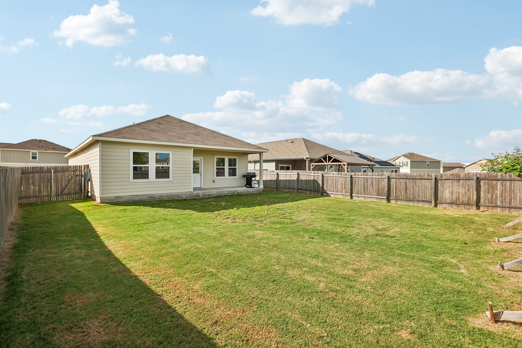 19105 Mike Mansfield Road Manor, TX 78653 - Photo 25 of 28 a view of a house with backyard and garden