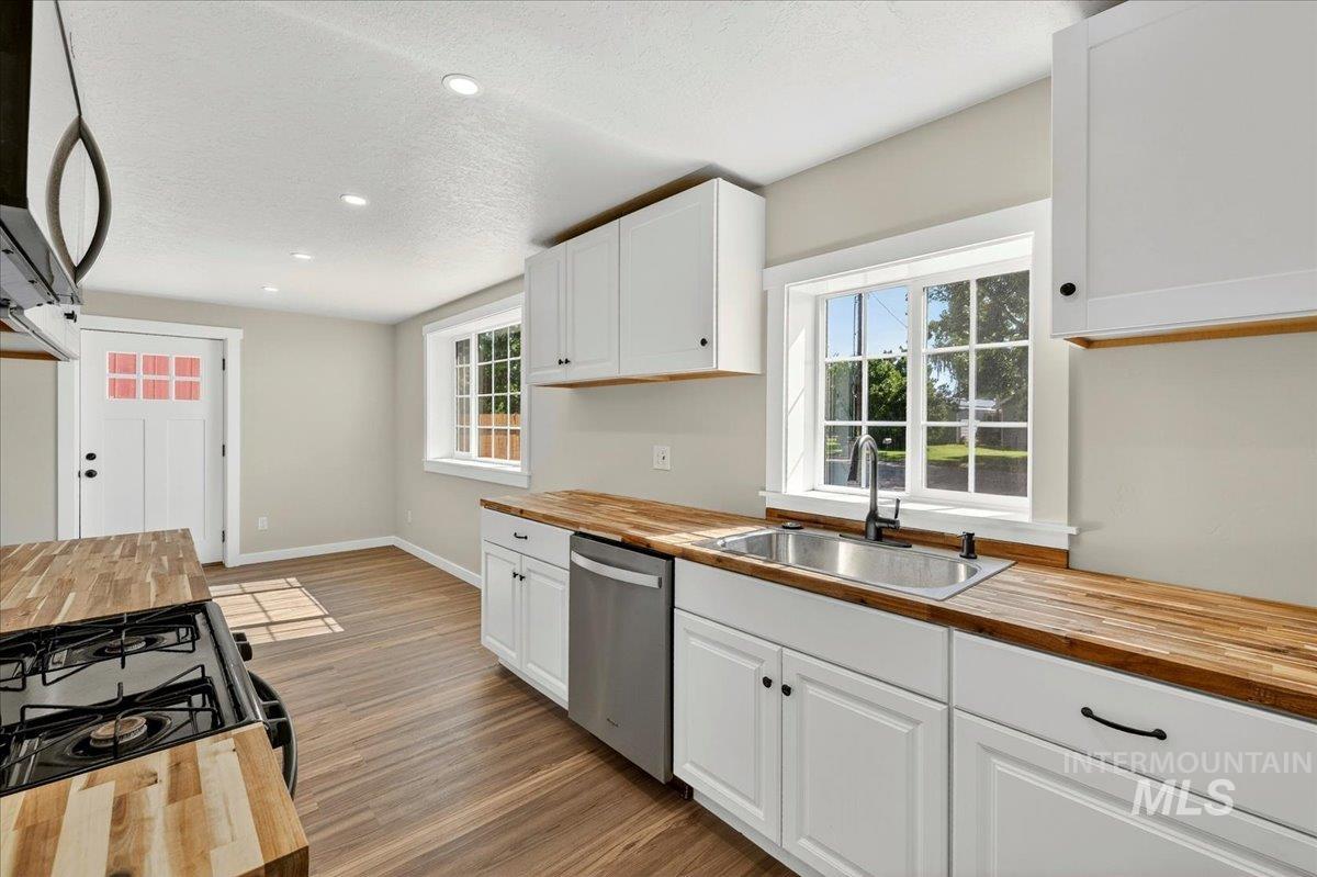 109 Parma Road Parma, ID 83660 - Photo 10 of 31 Kitchen featuring all new butcher block counters and white cabinetry