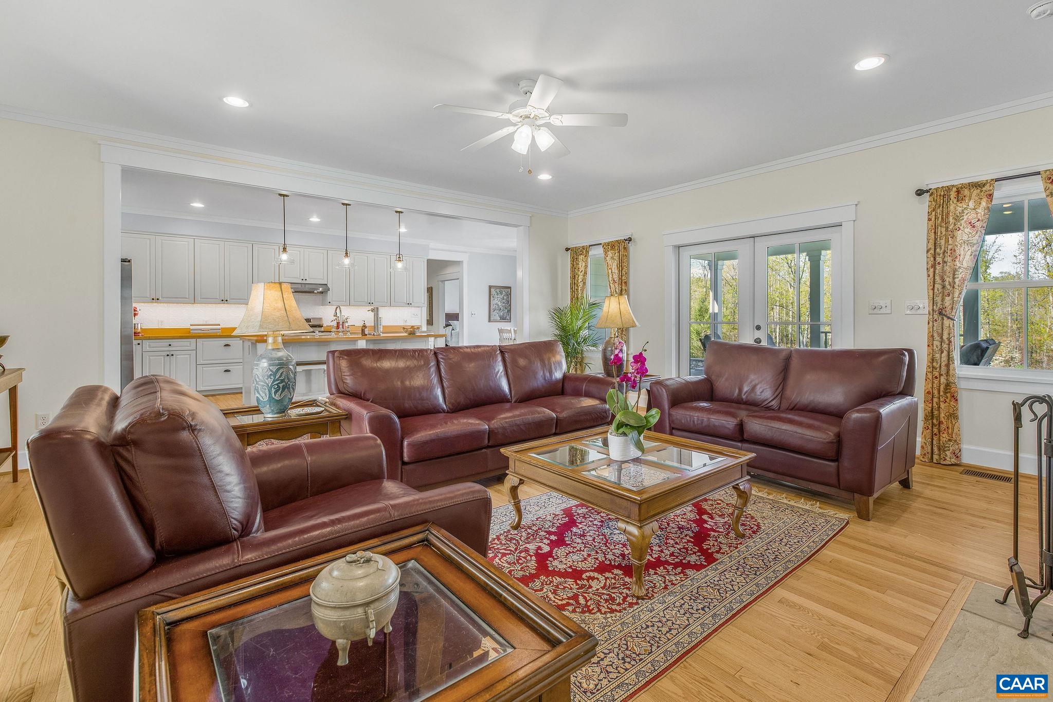 4764 Advance Mills Road Earlysville, VA 22936 - Photo 46 of 72 a living room with furniture a chandelier and a rug