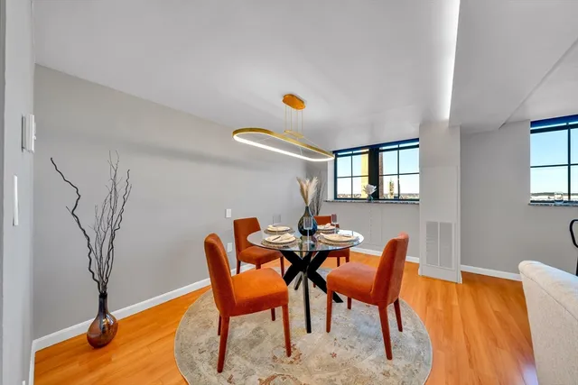 a dining room with furniture and wooden floor