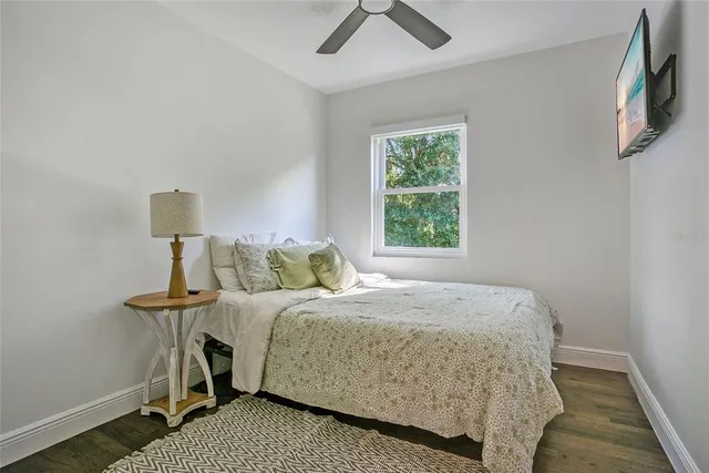 a bedroom with a bed and a lamp on the dresser