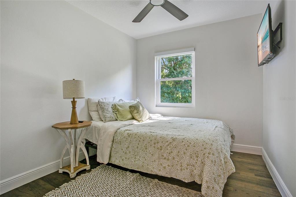 960 Strathmore Drive Orlando, FL 32806 - Photo 15 of 25 a bedroom with a bed and a lamp on the dresser