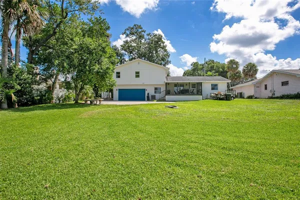 a view of a house with a yard and garage