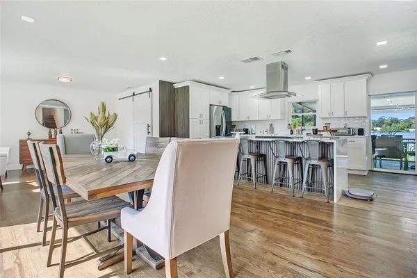 a view of a dining room with furniture and wooden floor