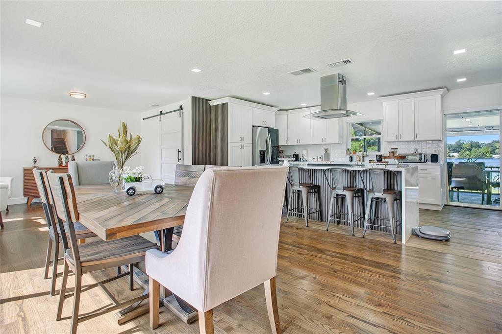 960 Strathmore Drive Orlando, FL 32806 - Photo 3 of 25 a view of a dining room with furniture and wooden floor