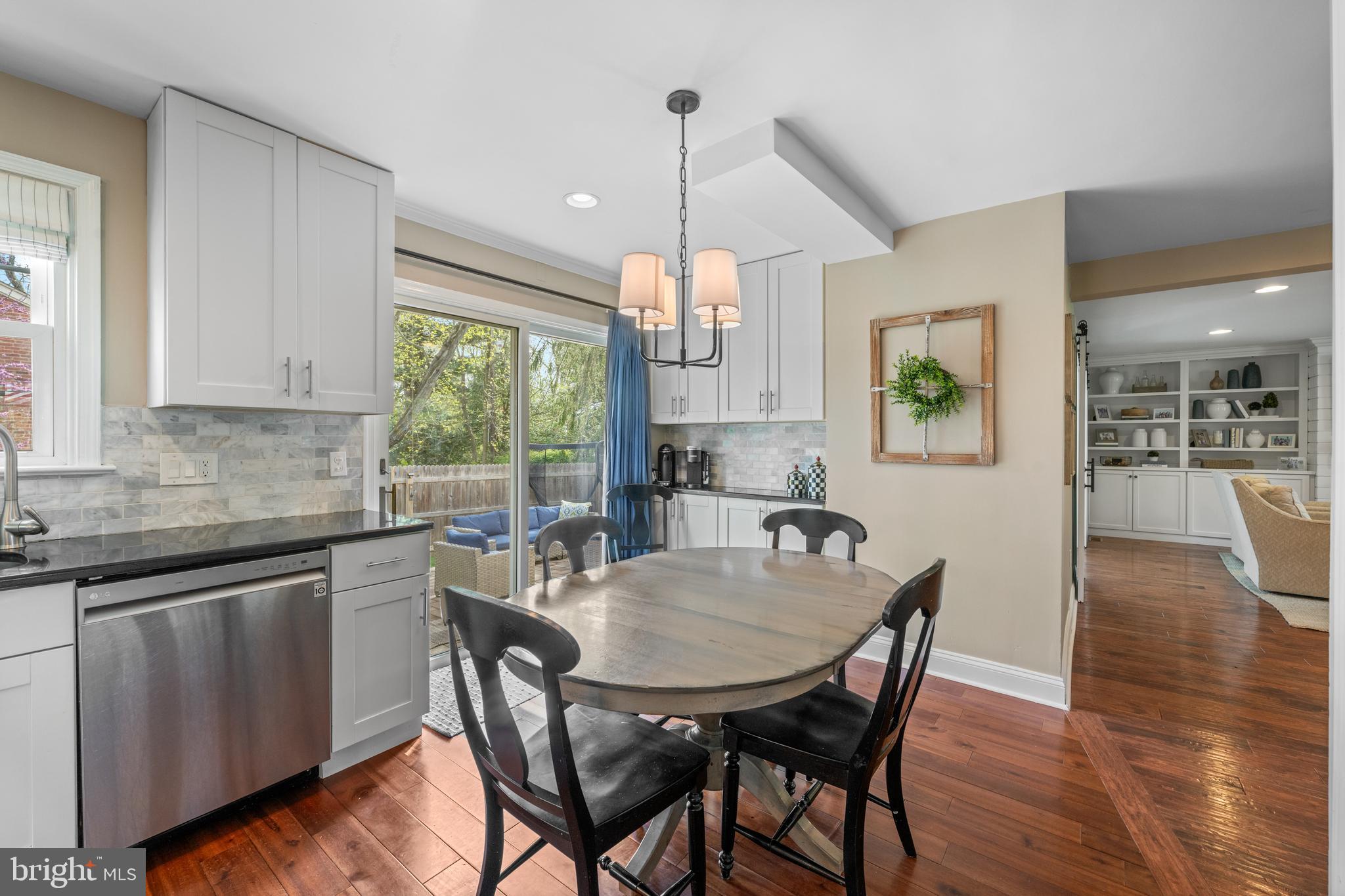 251 Rosedale Avenue Wayne, PA 19087 - Photo 21 of 53 a kitchen with stainless steel appliances granite countertop wooden floor dining table and chairs