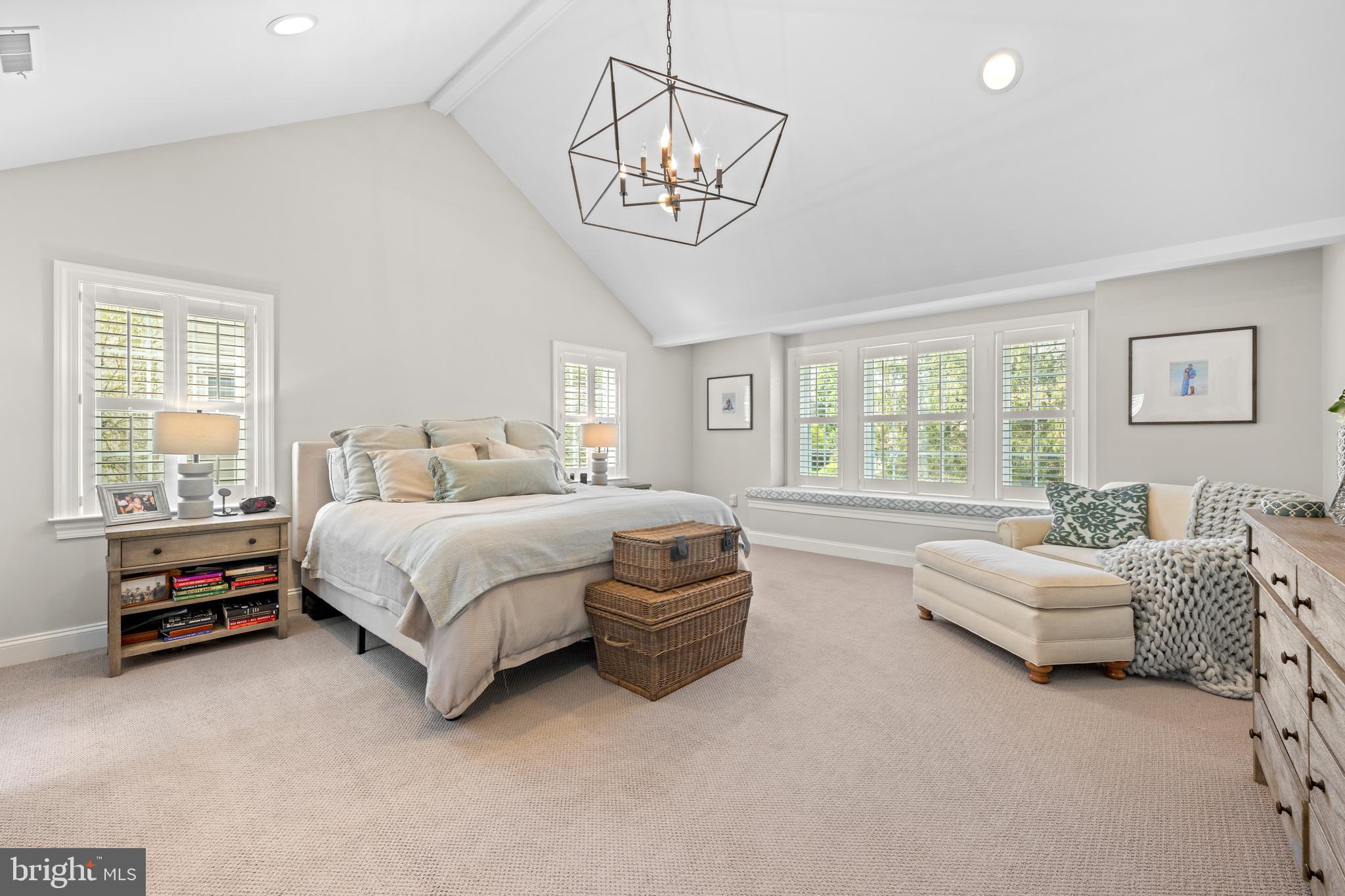 251 Rosedale Avenue Wayne, PA 19087 - Photo 27 of 53 a spacious bedroom with a bed a chandelier and a window