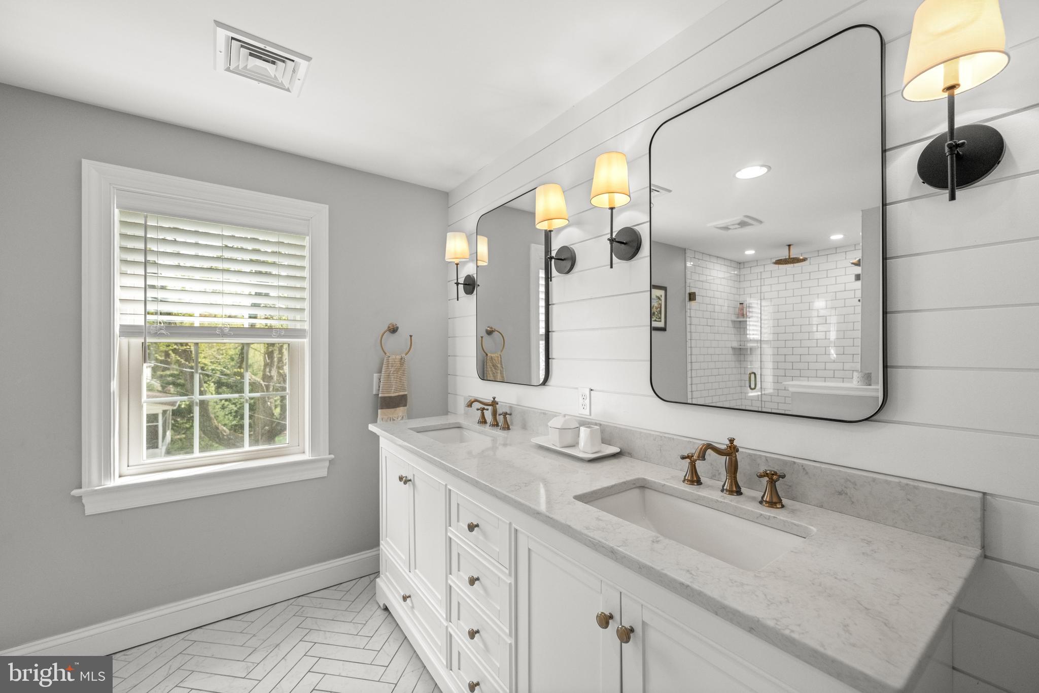 251 Rosedale Avenue Wayne, PA 19087 - Photo 29 of 53 a bathroom with double vanity sinks and a mirror