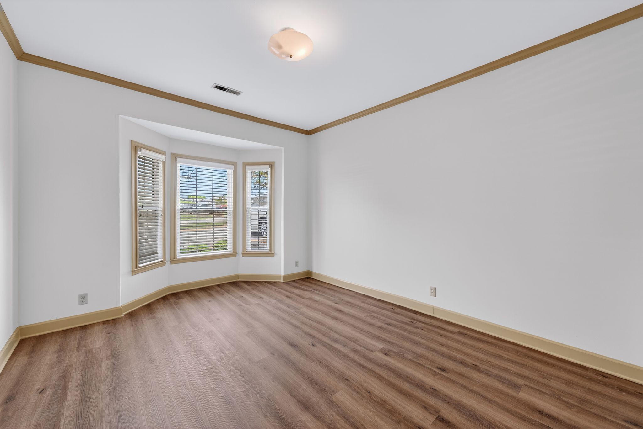2041 Union Place Columbia, TN 38401 - Photo 13 of 24 a view of an empty room with wooden floor and a window