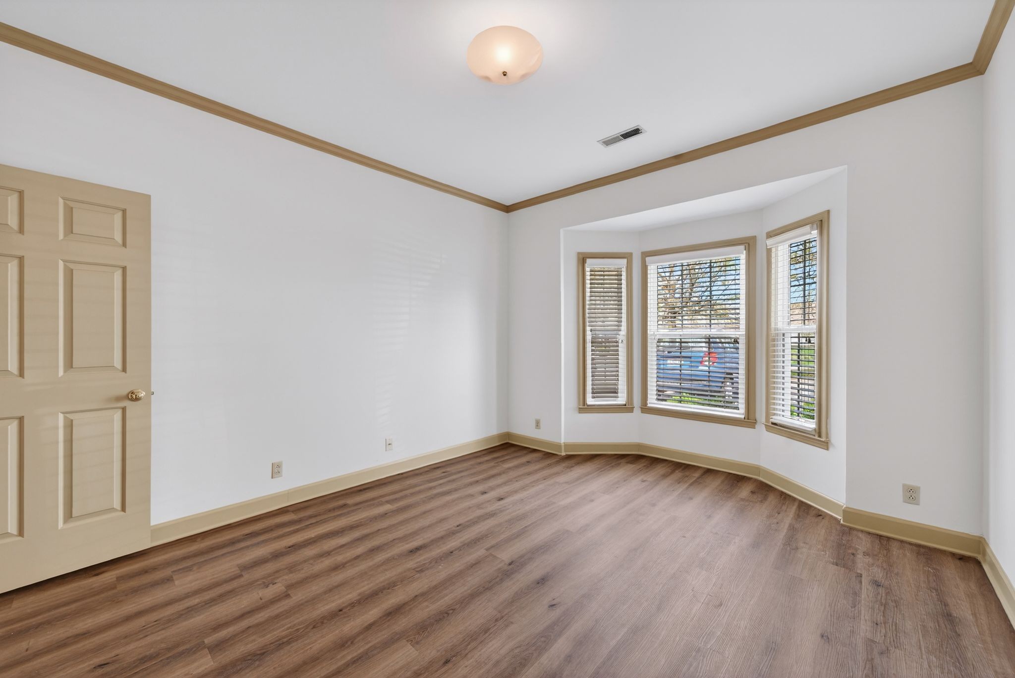 2041 Union Place Columbia, TN 38401 - Photo 14 of 24 a view of an empty room with wooden floor and a window