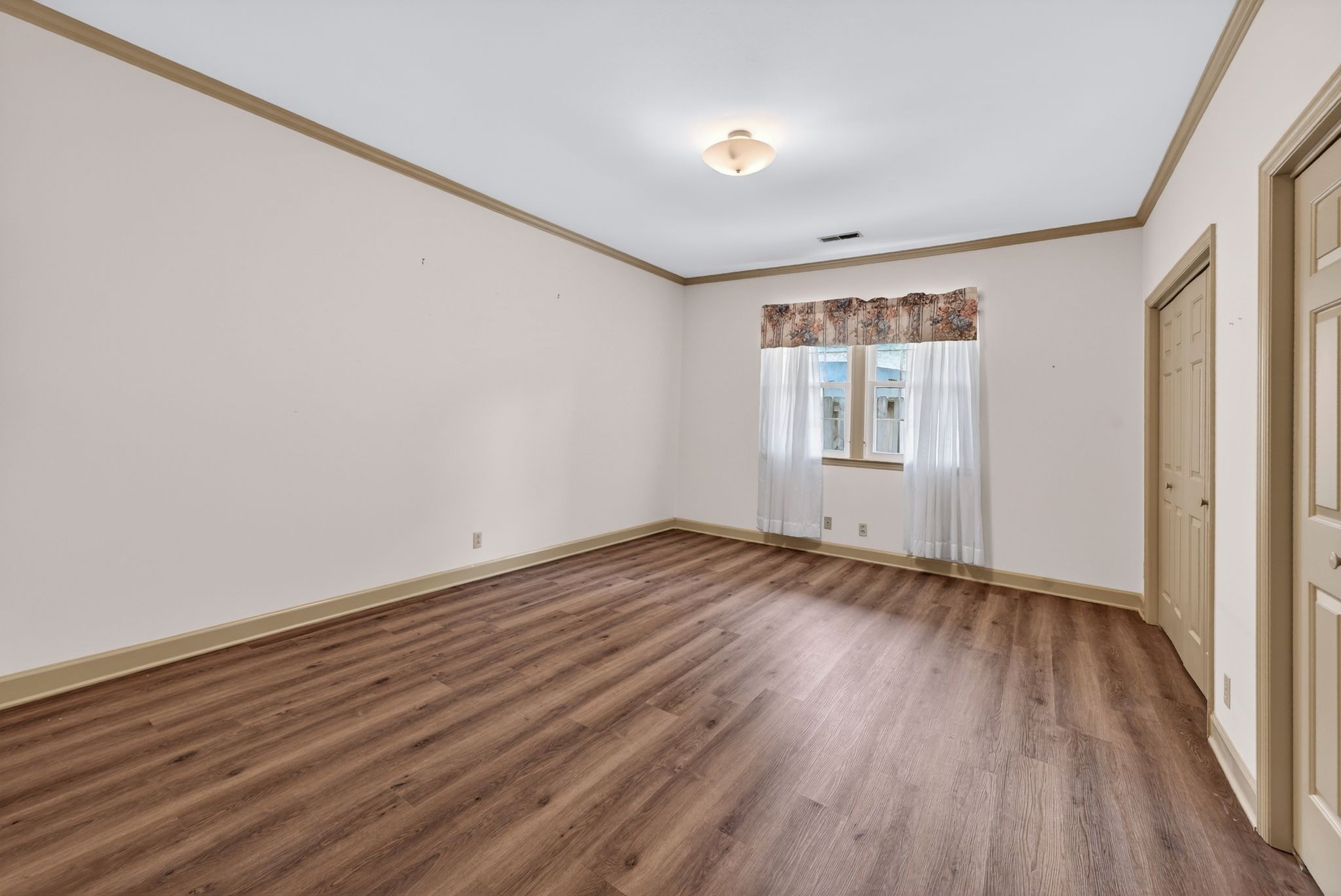 2041 Union Place Columbia, TN 38401 - Photo 16 of 24 a view of an empty room with wooden floor and a window