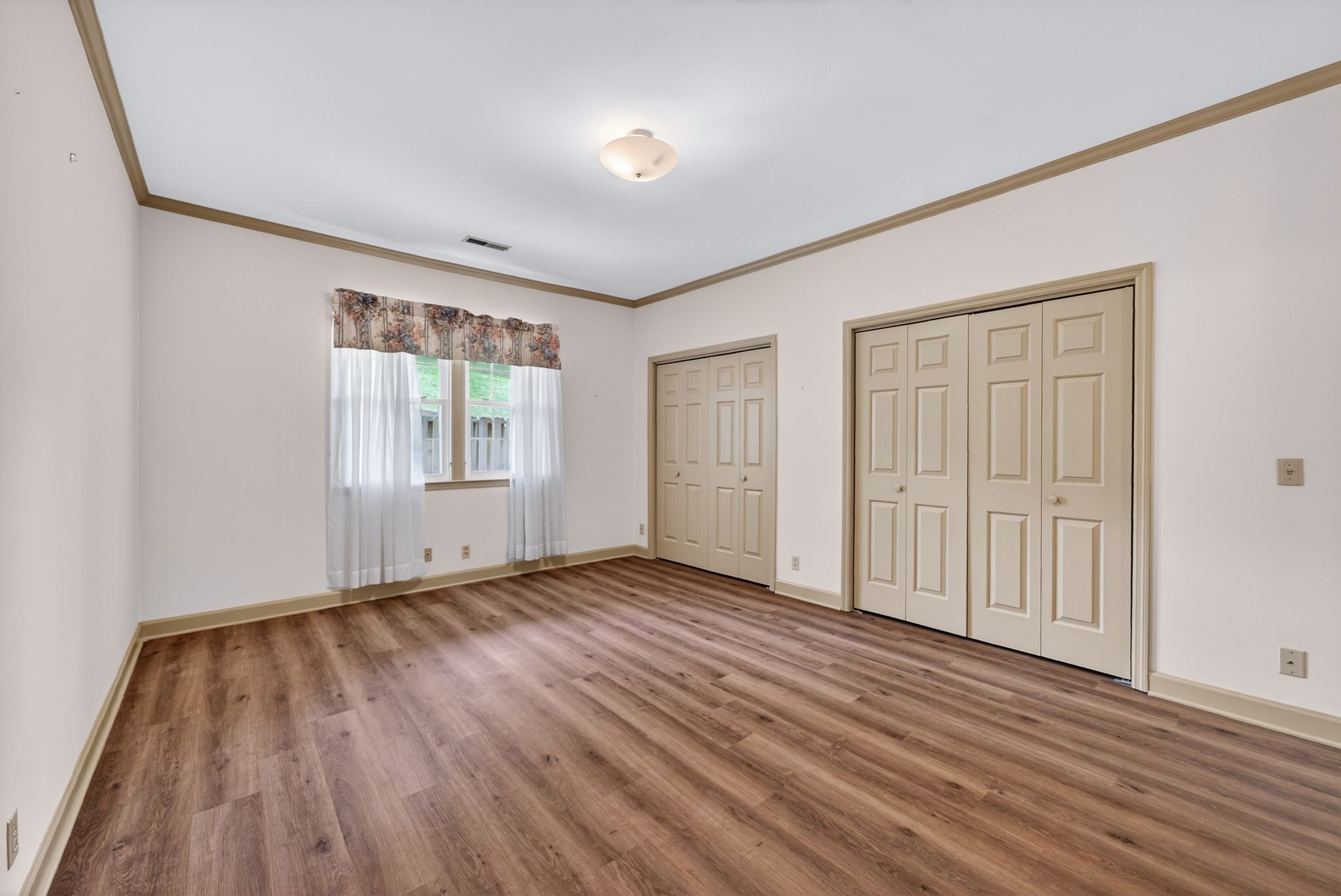 2041 Union Place Columbia, TN 38401 - Photo 17 of 24 a view of an empty room with wooden floor and a window