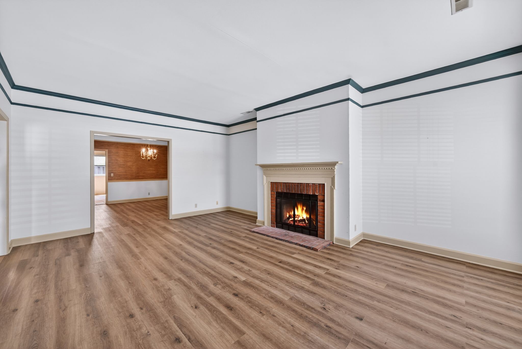 2041 Union Place Columbia, TN 38401 - Photo 4 of 24 a view of an empty room with wooden floor a fireplace and a window