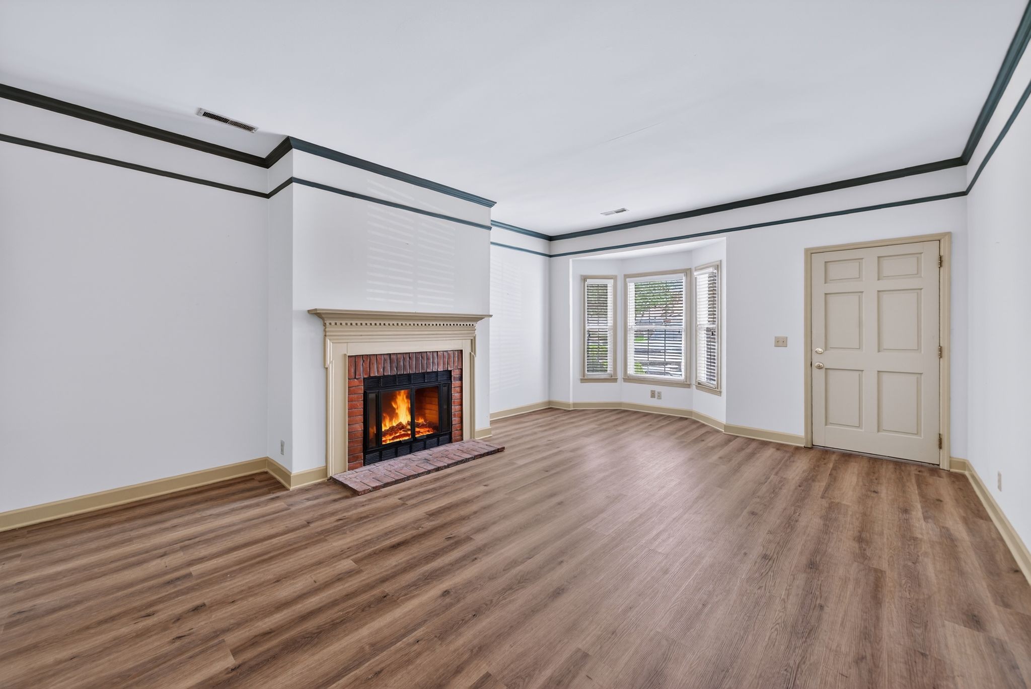 2041 Union Place Columbia, TN 38401 - Photo 5 of 24 a view of an empty room with wooden floor fireplace and a window