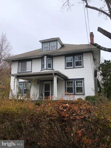 a view of a white house with large windows