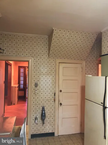 a view of a living room with wooden floor and a window