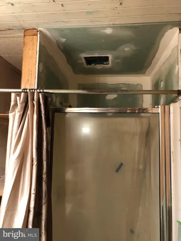 a view of a livingroom with wooden floor and a ceiling fan