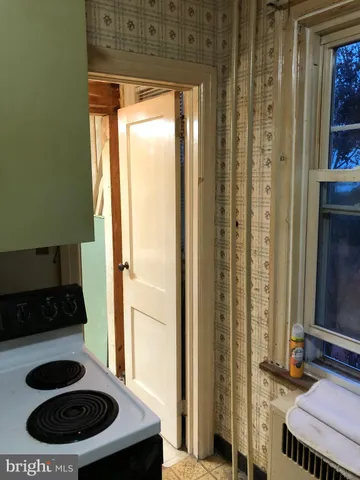 a view of a room with wooden floor and a window